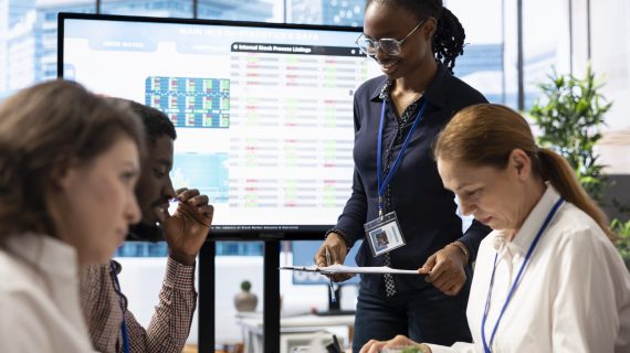 Business analyst creating an interactive board presentation with project updates and goals to ensure international enterprise success. Works on allocating resources according to the market needs.